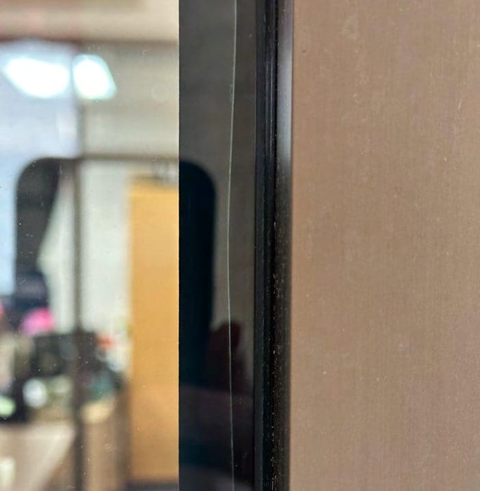 Hand-cut film, stopped short of the edge: Hand-cut edge, film well short of the glass edge.