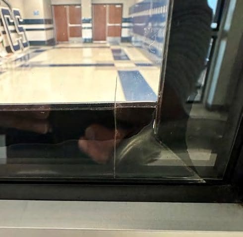 A non-3M attachment on 3M film: Air pockets under the attachment; film pulling away from the glass.