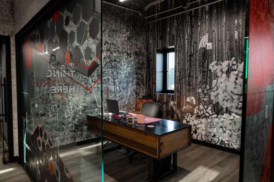 Small office with a printed birch-forest wall and frosted hexagon glass on the left