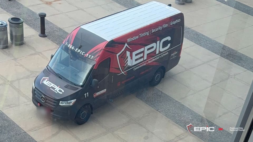 The Epic van parked on the plaza outside the stadium glass at AT&T Stadium, seen from inside on sample day