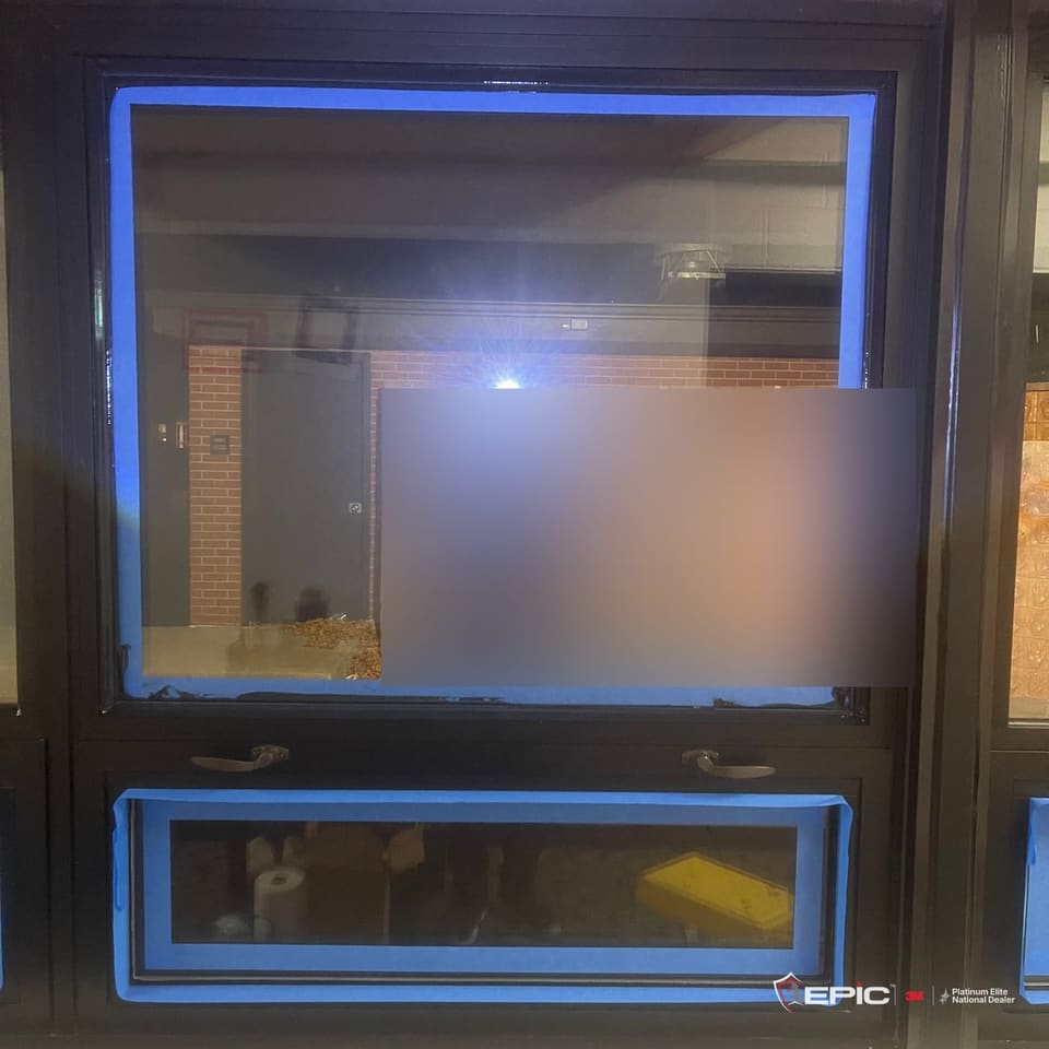 A hallway window at night with the film on and both lites taped in blue for the bead
