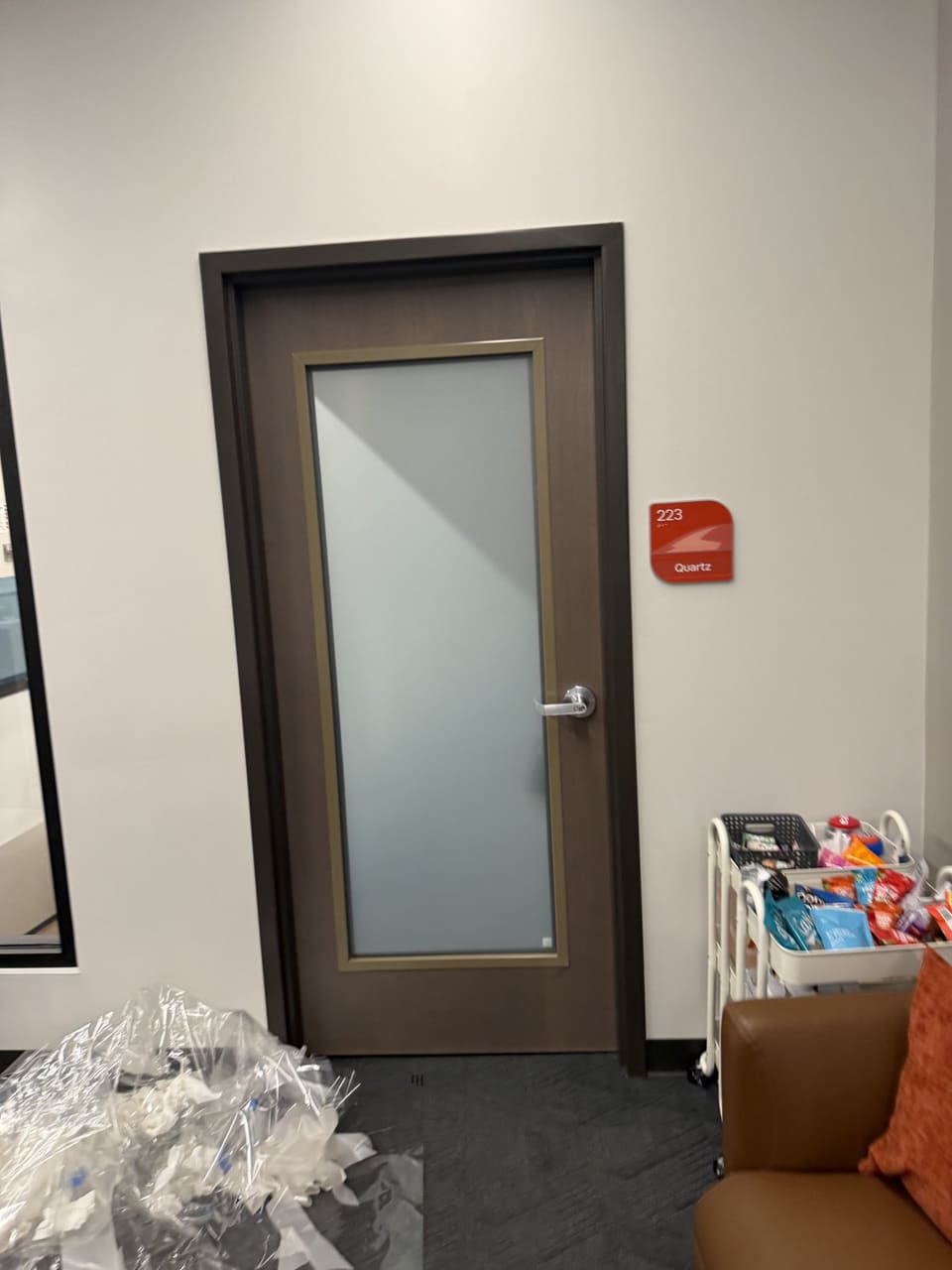 The frosted office door in a school hallway