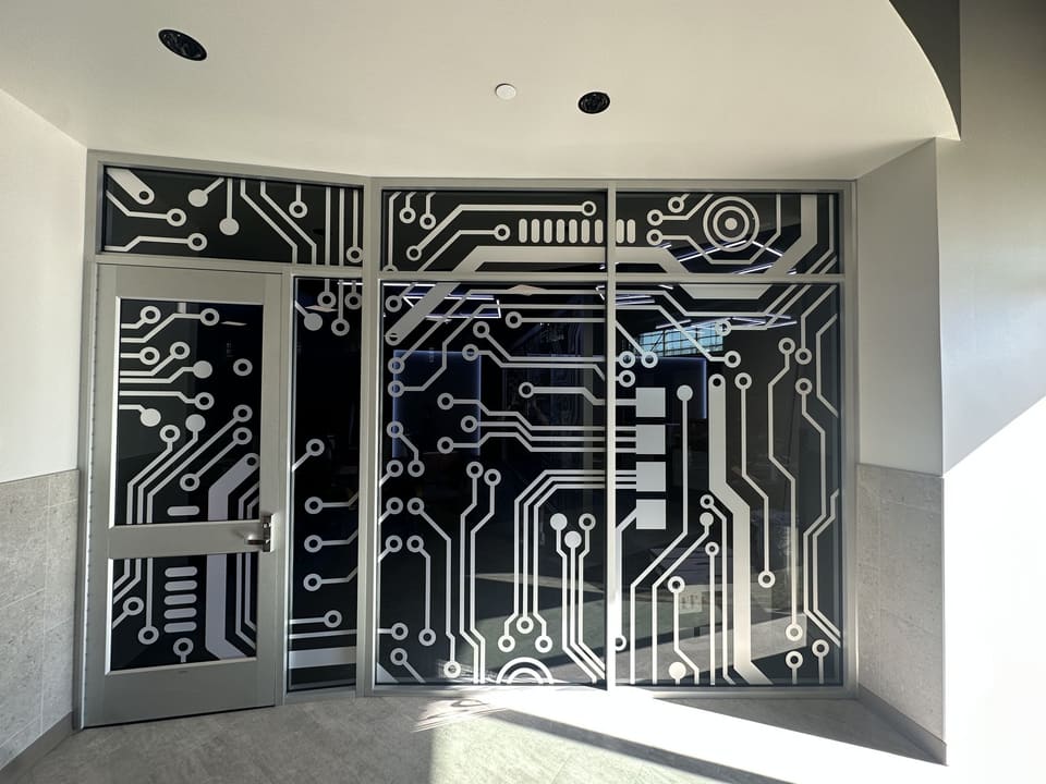 Esports room glass doors with a printed circuit-board graphic installed by Epic