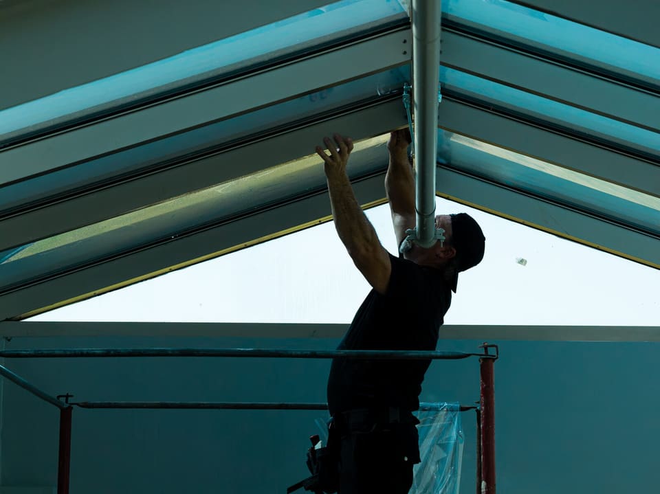 Epic crew working on the atrium glass and skylight at the Oklahoma Department of Wildlife Conservation during the film install