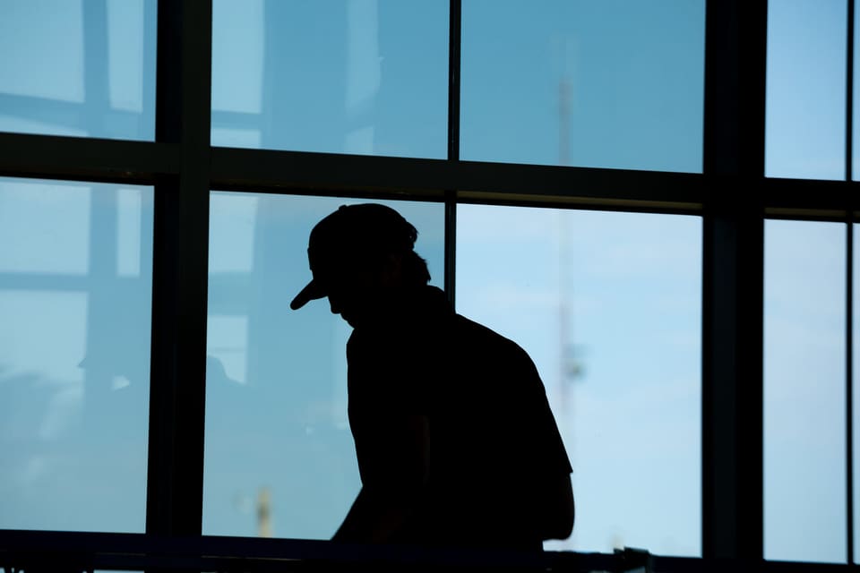 Epic installer silhouetted against the atrium glass during the film install at the Oklahoma Department of Wildlife Conservation
