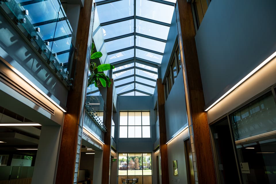 Atrium at the Oklahoma Department of Wildlife Conservation in Oklahoma City: timber columns under a glass skylight with 3M window film