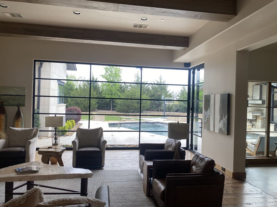 Living room looking out to the pool through clear 3M window film installed by Epic