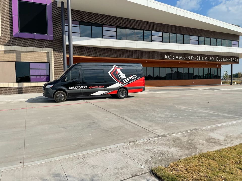 Epic installation van in front of Rosamond-Sherley Elementary, a Texas campus protected with 3M security window film